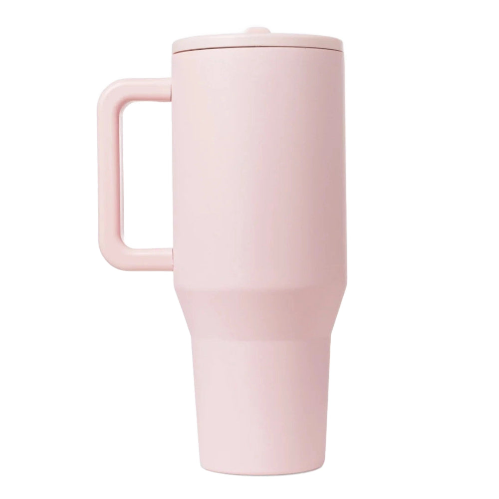 A side photo of a pink travel mug with a handle on a white background.