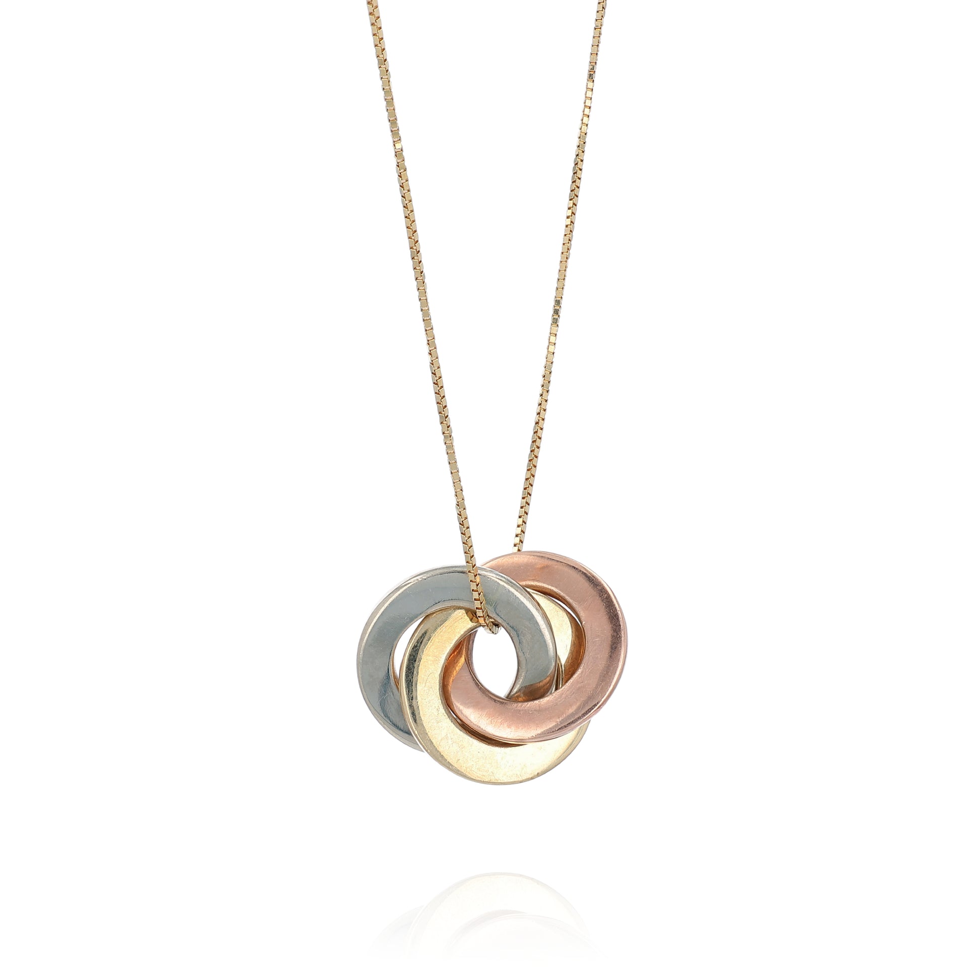 A three-tone metal pendant necklace featuring interlocking rings in yellow gold, rose gold, and silver, suspended from a delicate gold chain against a white background.