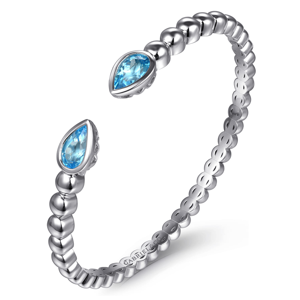 Silver ring with blue gemstones on a white background