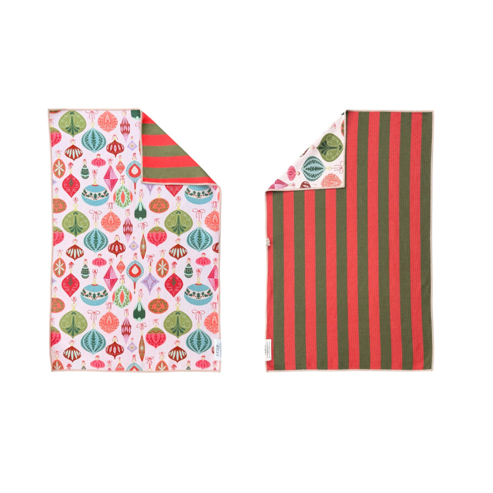 Reversible hand towel showing both sides with holiday-themed patterns on a plain white background.