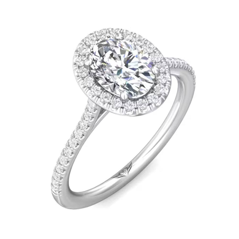Diamond ring with a halo and pavé setting on a white background