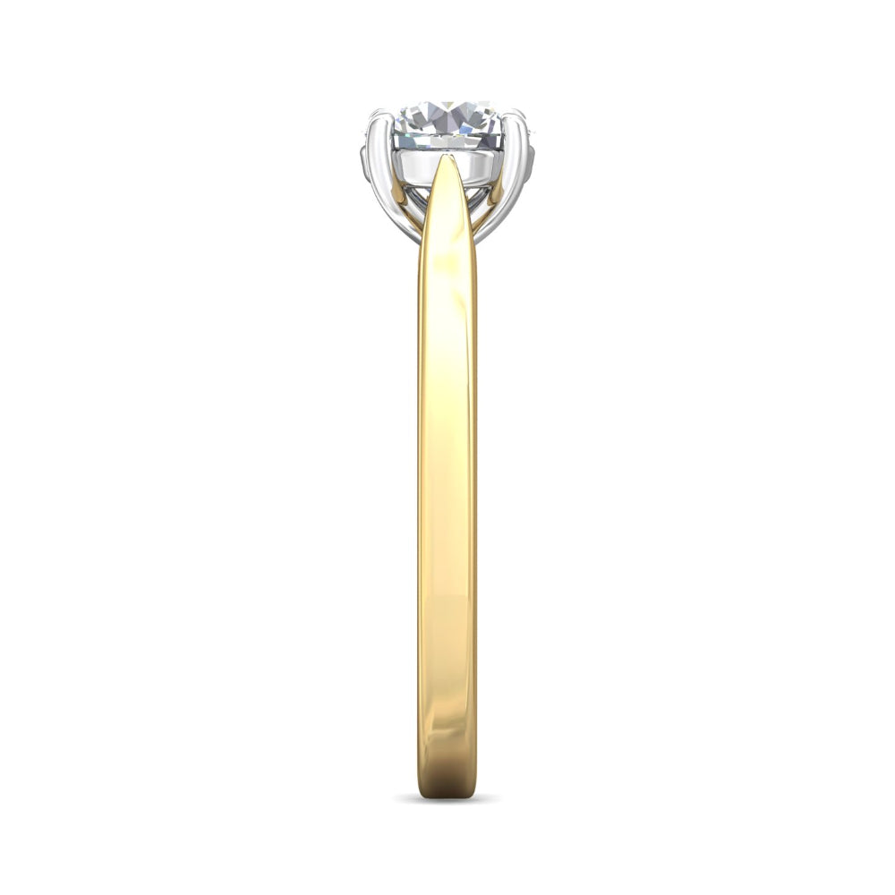 A side-view shot of a diamond solitaire engagement ring featuring a yellow gold band and a white gold or platinum prong setting with a round brilliant-cut diamond, isolated on a white background.