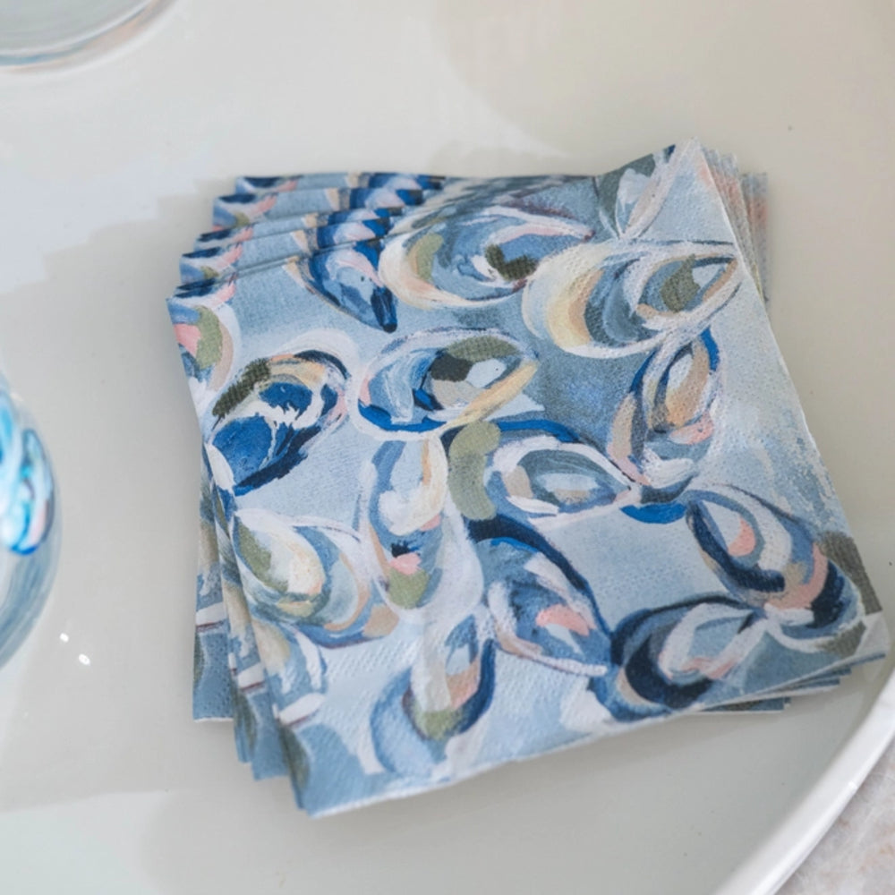 Stack of blue patterned napkins on a white surface