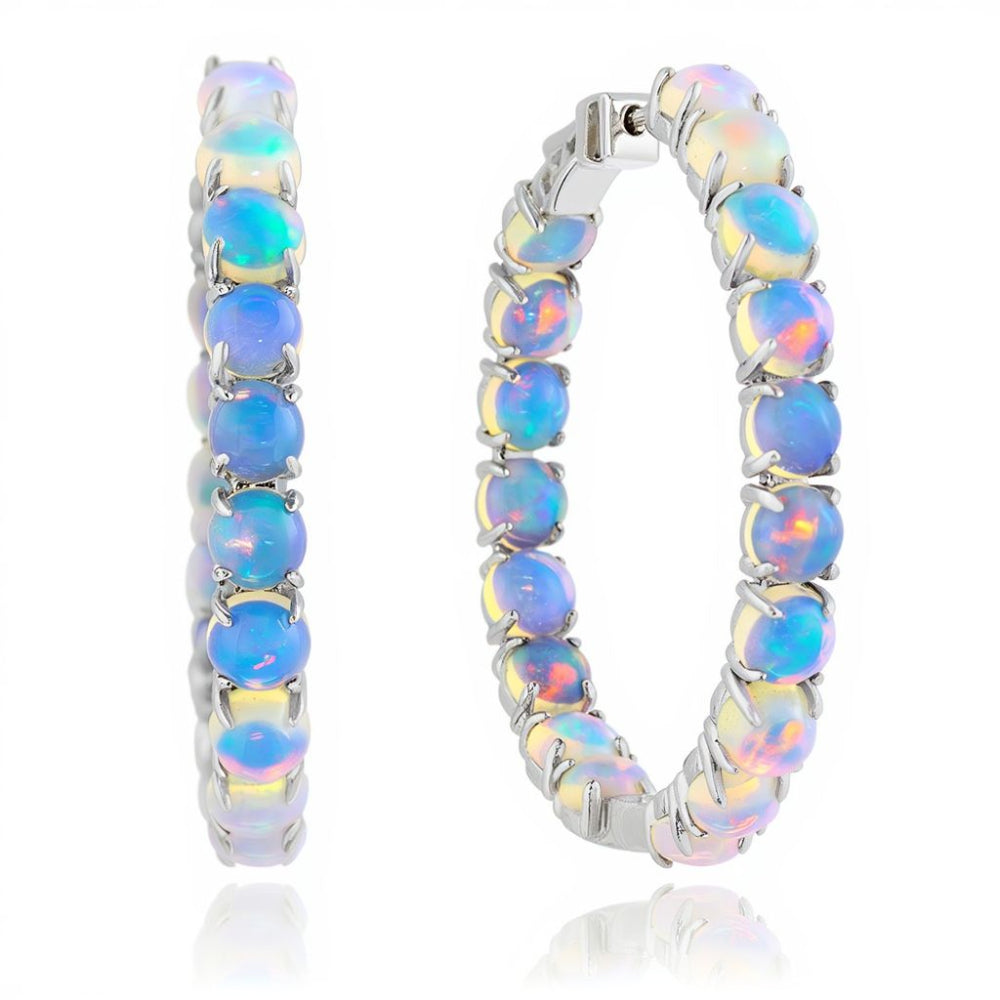 In and out opal hoop earrings on a white background