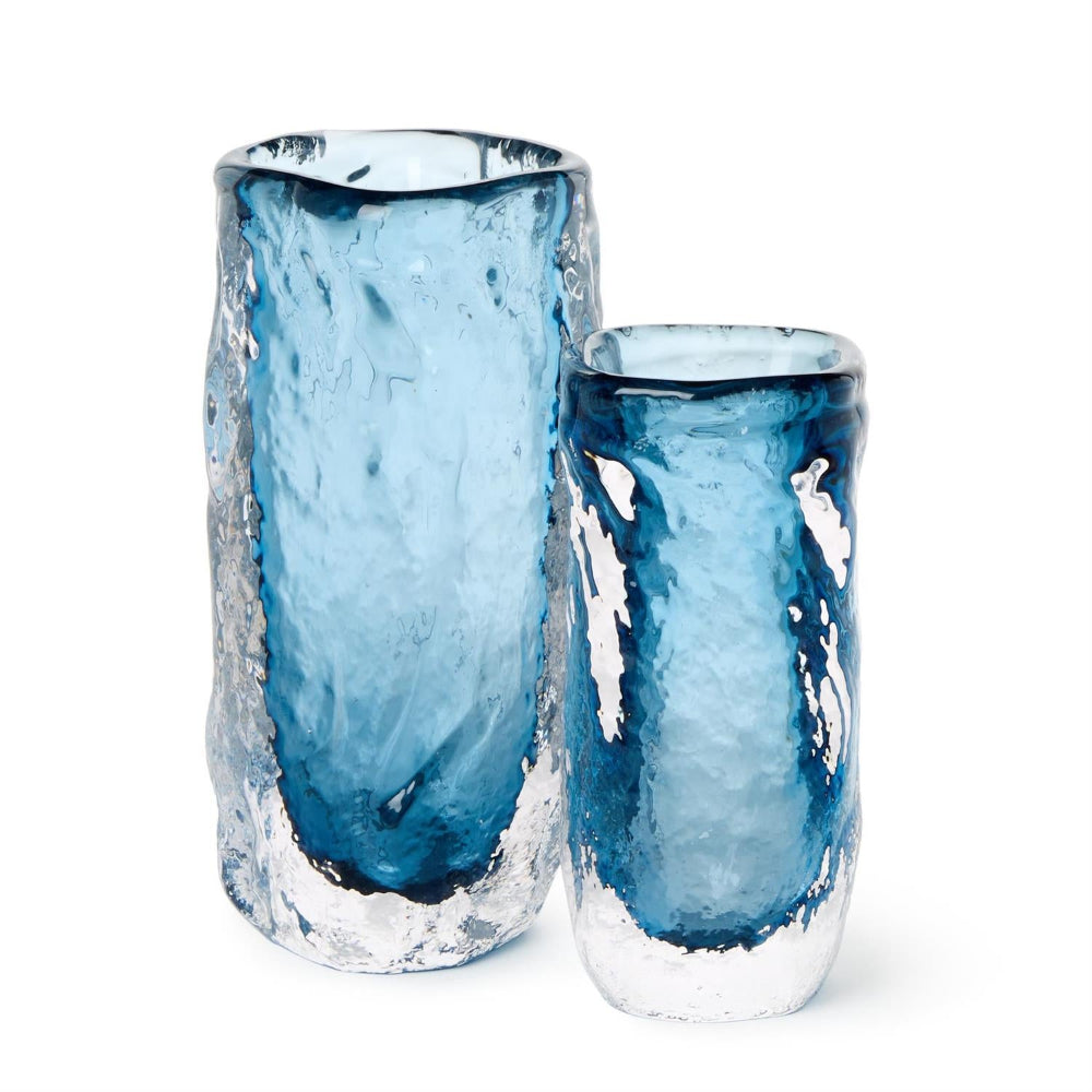 Two blue glass vases with textured surfaces on a white background