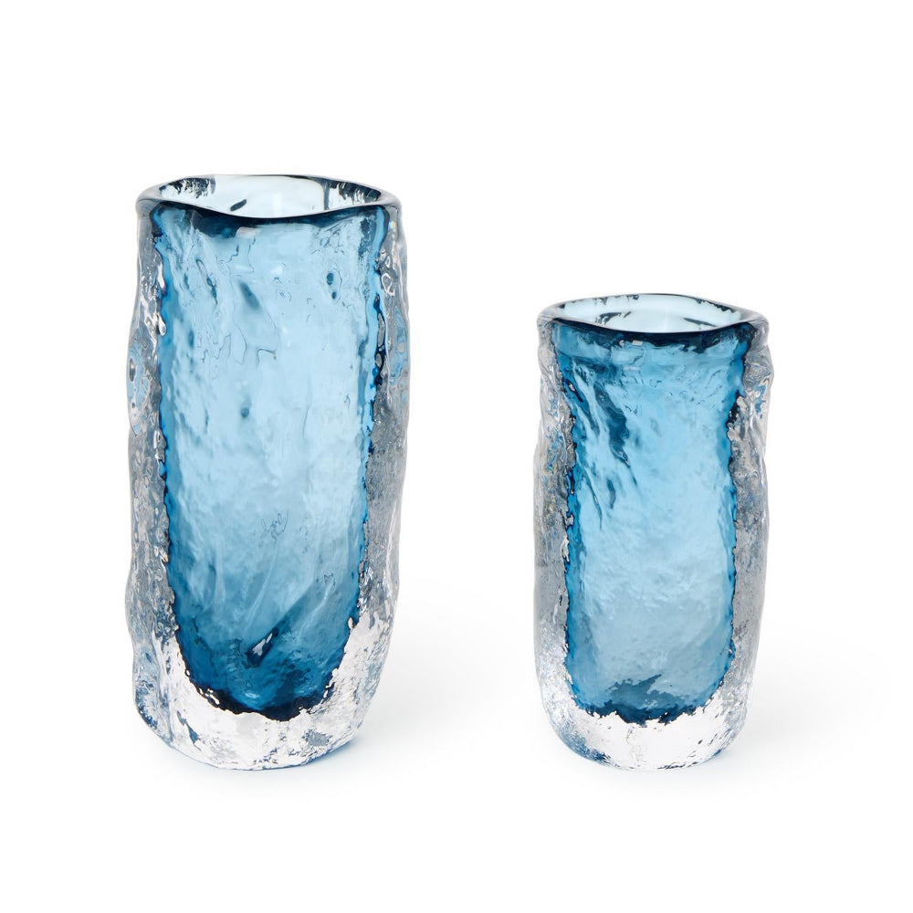 Two blue glass vases with textured surfaces on a white background.