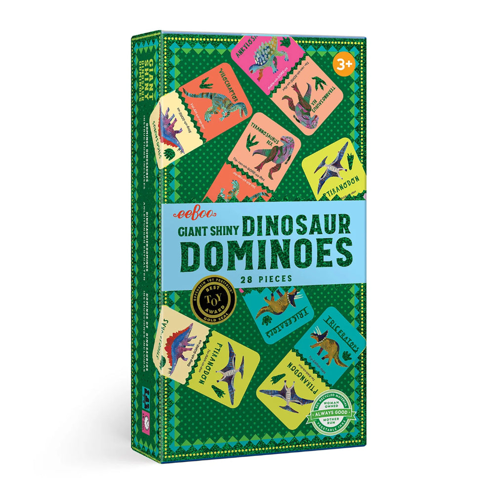 Box of giant shiny dinosaur dominoes with colorful dinosaur illustrations on a green background