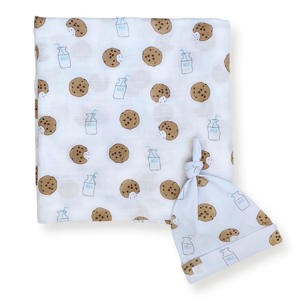 Baby blanket and hat set with cookie and milk pattern on a white background