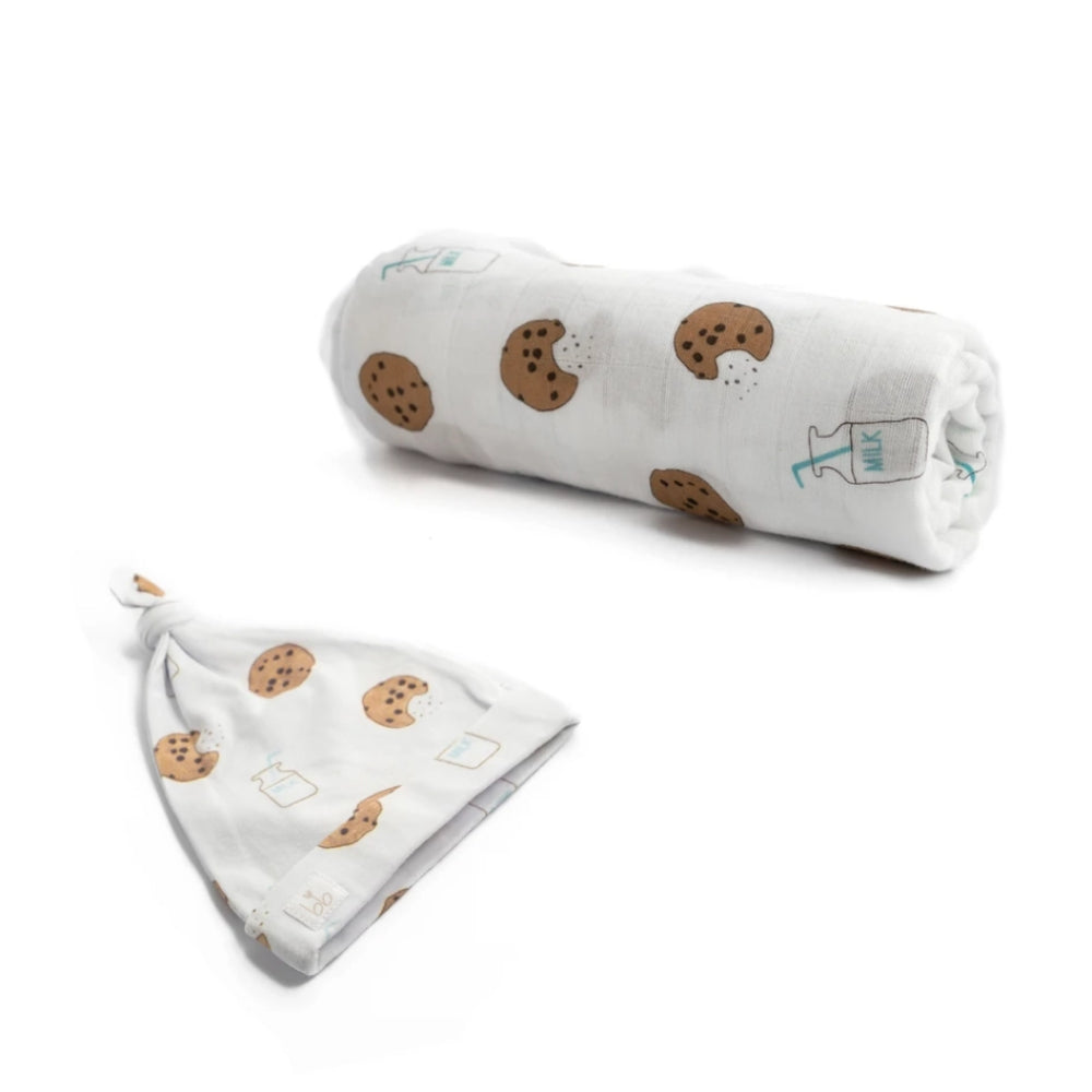 Baby blanket and hat set with cookie and milk pattern on a white background