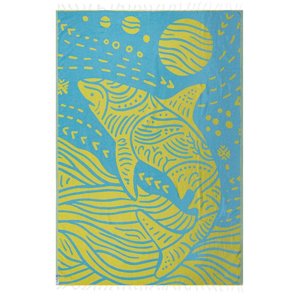 Side two of a beach towel with a blue and yellow shark design with a white tassel edge on a white background.