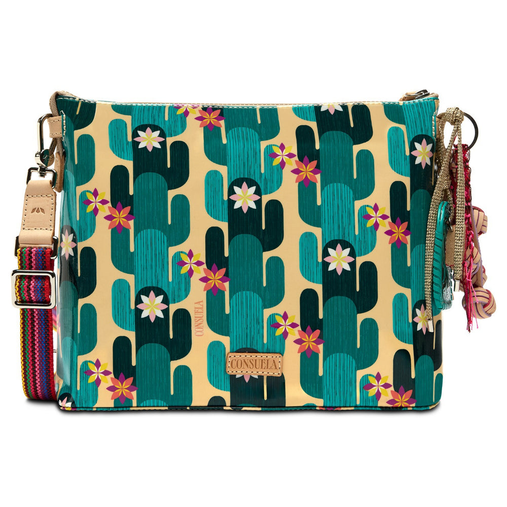 Colorful handbag with cactus and flower pattern on a beige background