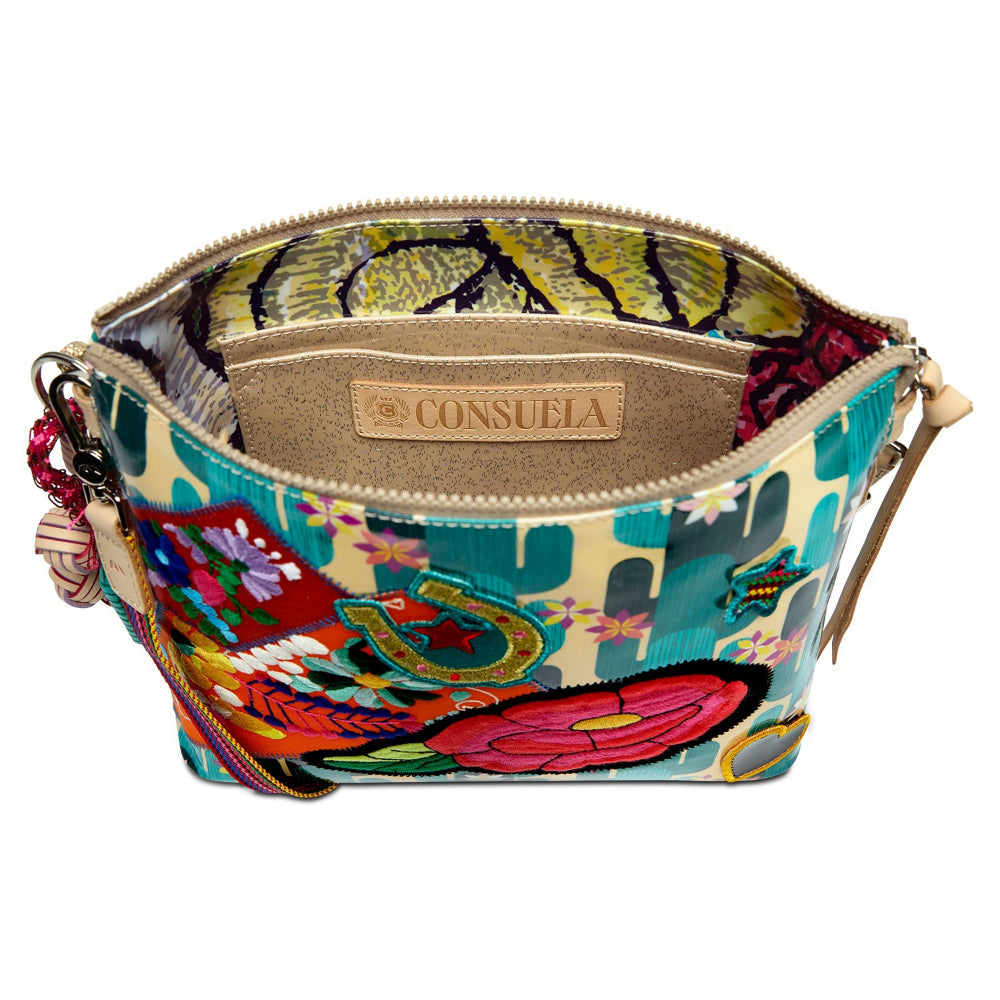 Colorful handbag with floral and cactus design, featuring Consuela brand on a white background.