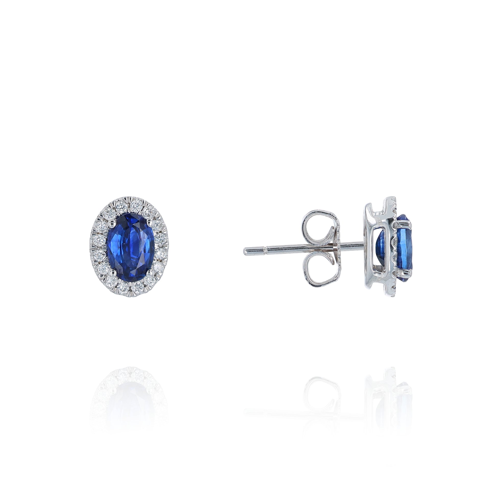 Pair of sapphire and diamond halo stud earrings on a white background