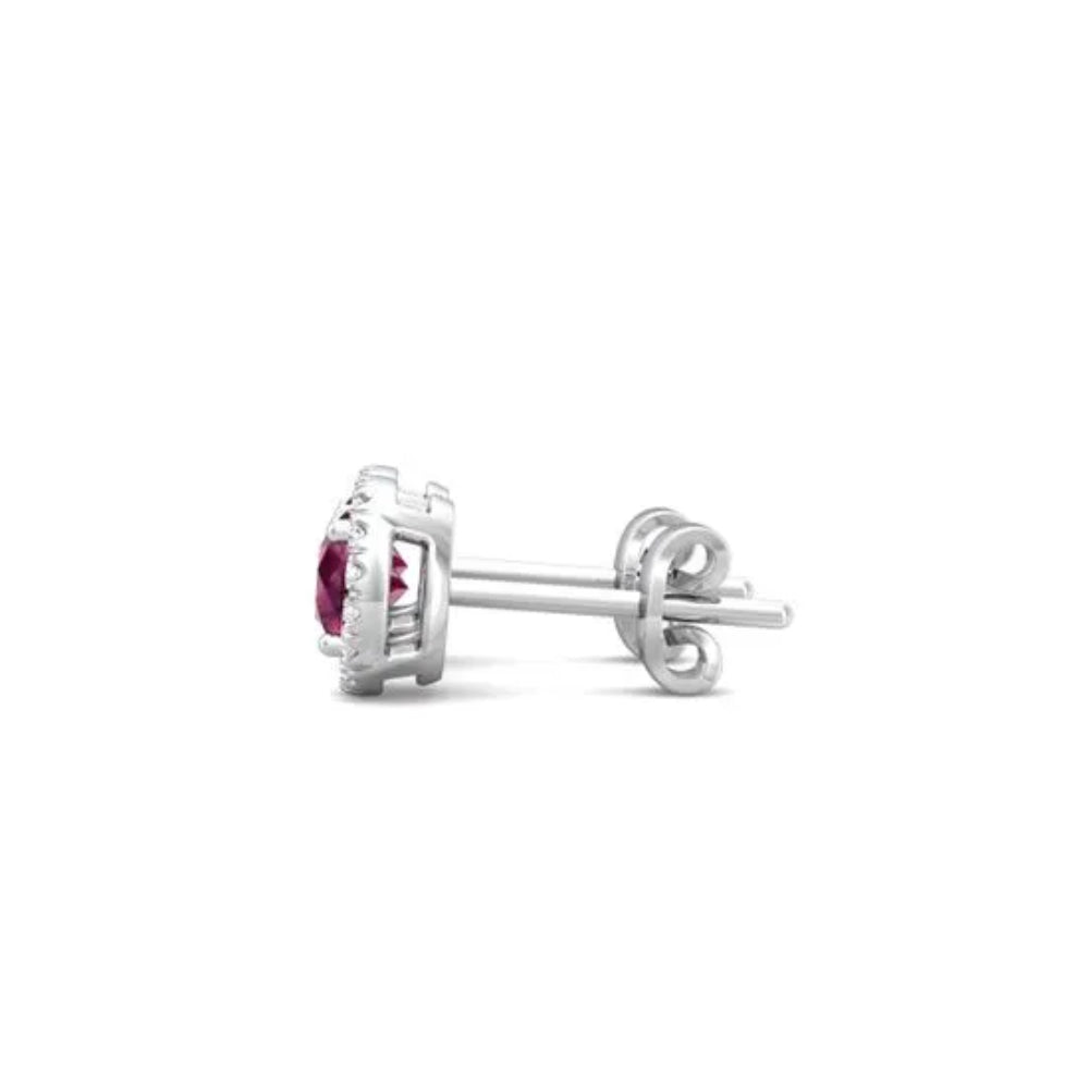 White gold ruby and diamond halo stud earrings on a white background