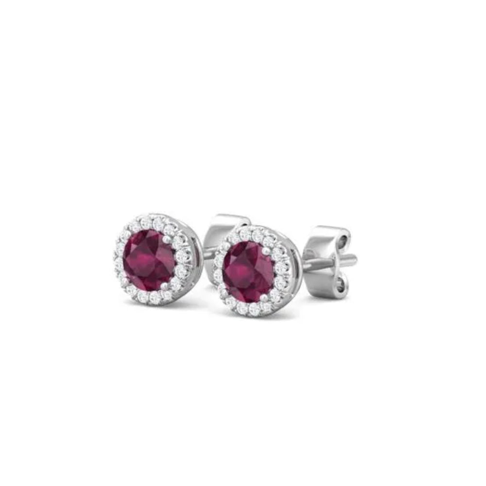 White gold ruby and diamond halo stud earrings on a white background