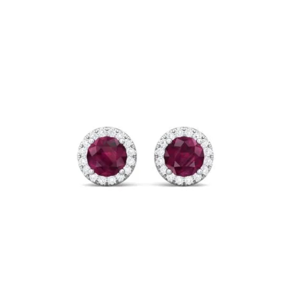 White gold ruby and diamond halo stud earrings on a white background