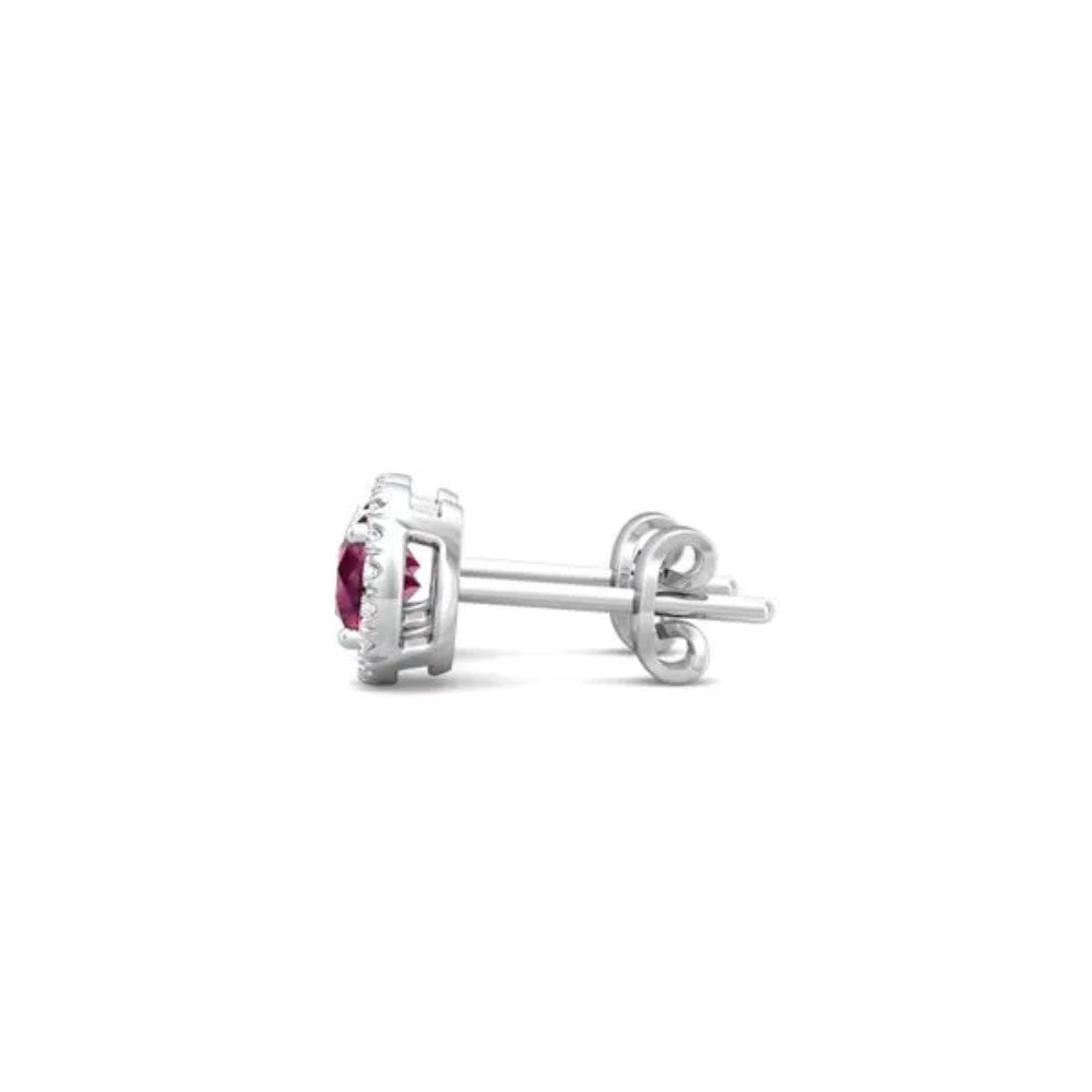 White gold ruby and diamond halo stud earrings on a white background