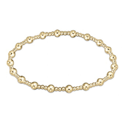 Gold beaded bracelet on a white background
