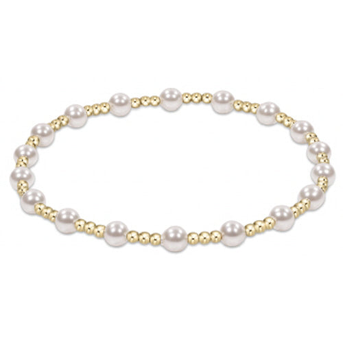 Pearl bracelet with gold accents on a white background
