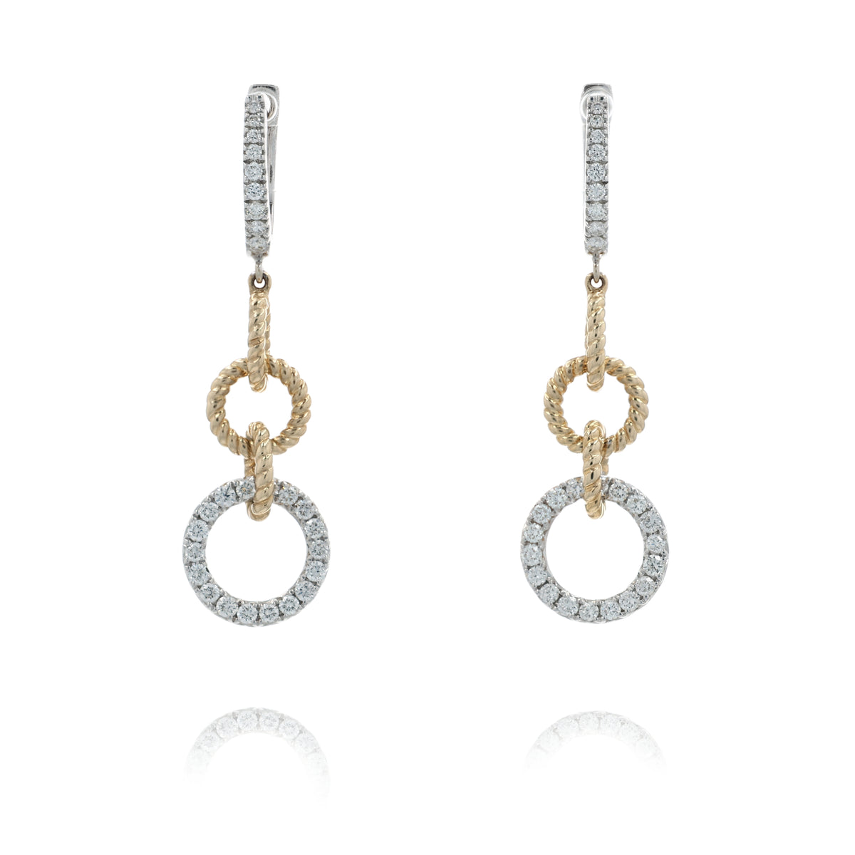 A pair of gold and silver drop earrings with pavé-set clear stones, featuring a textured rope-style ring, a smaller circular ring, and a larger pavé-set circular drop, shown on a white background with a soft reflection below.