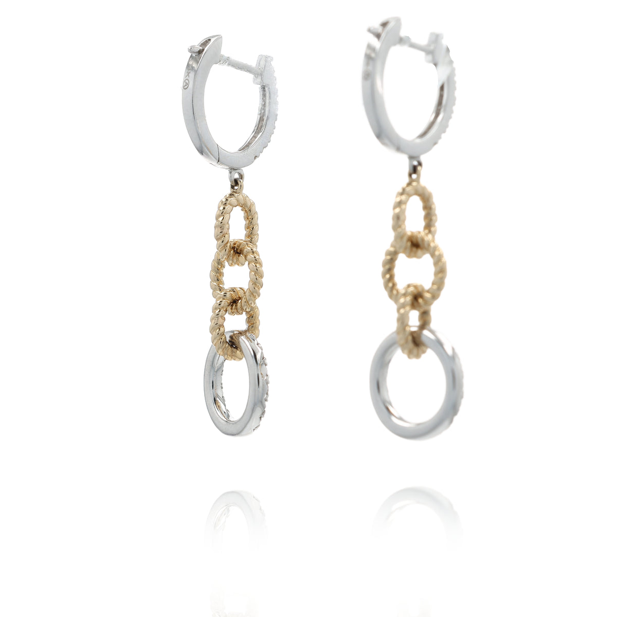 A pair of silver and gold drop hoop earrings with textured chain links and circular dangling elements, shown on a clean white background with a soft reflection below.
