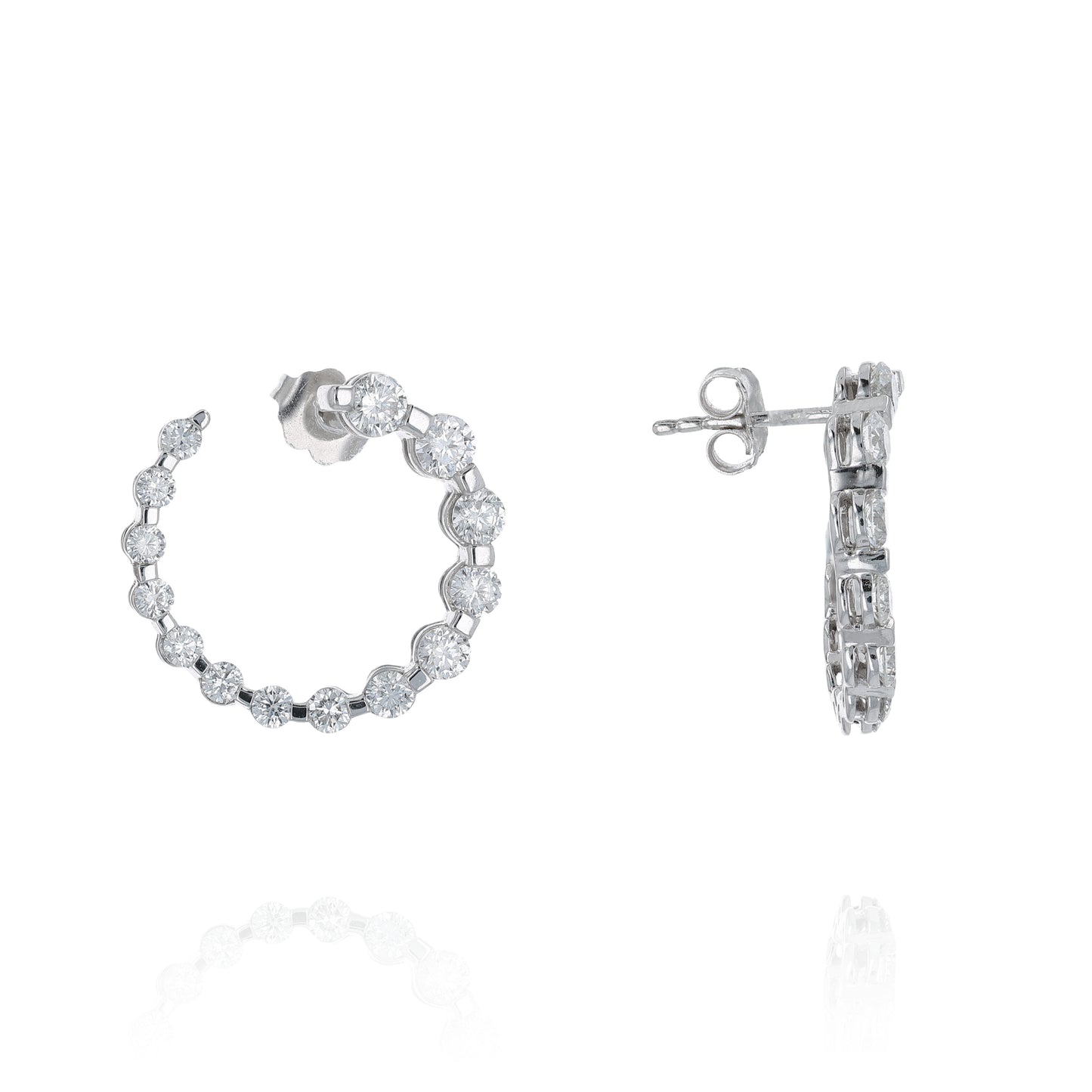 Pair of white gold drop earrings with graduated diamonds on a white background