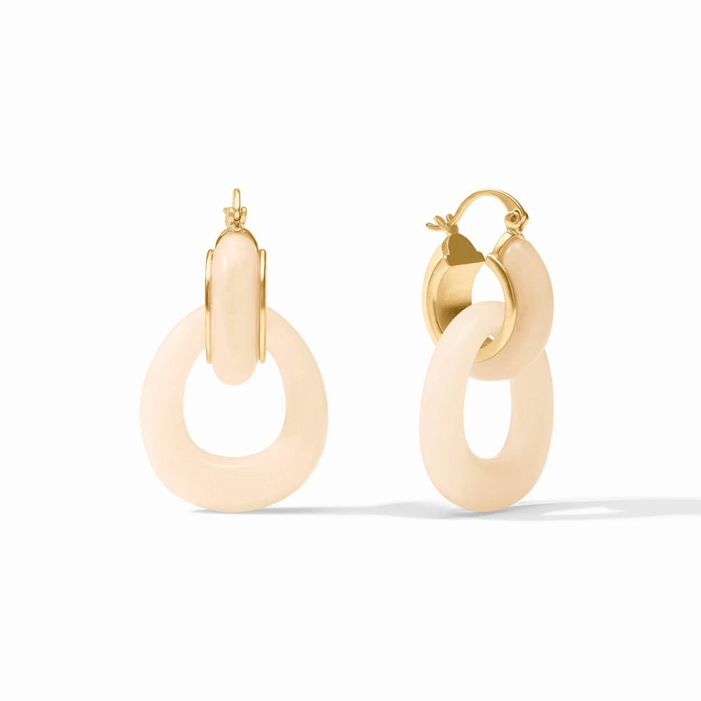 Pair of gold hoop earrings with IVORY circular pendants on a white background