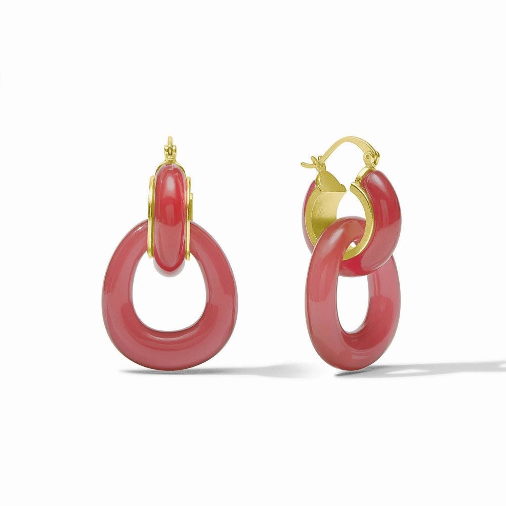 Pair of red hoop earrings with gold accents on a white background
