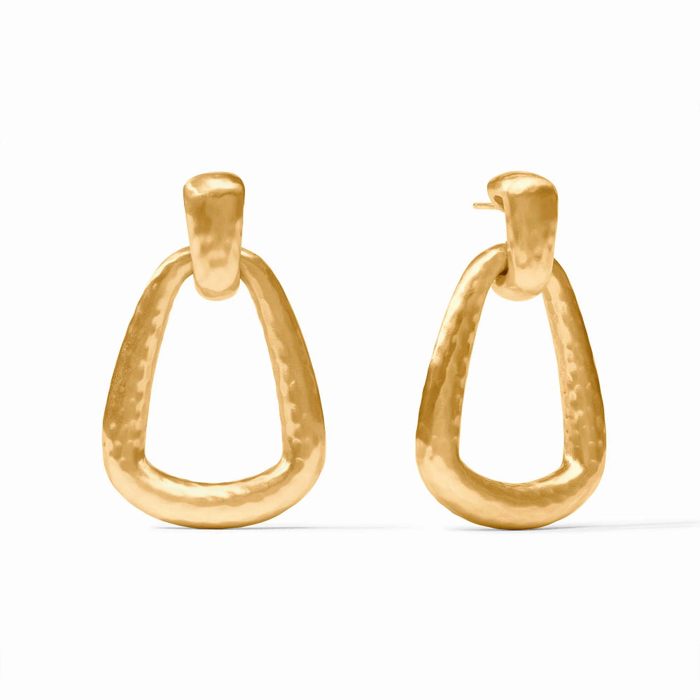 A pair of gold-tone open hoop earrings with a hammered texture, displayed against a clean white background.