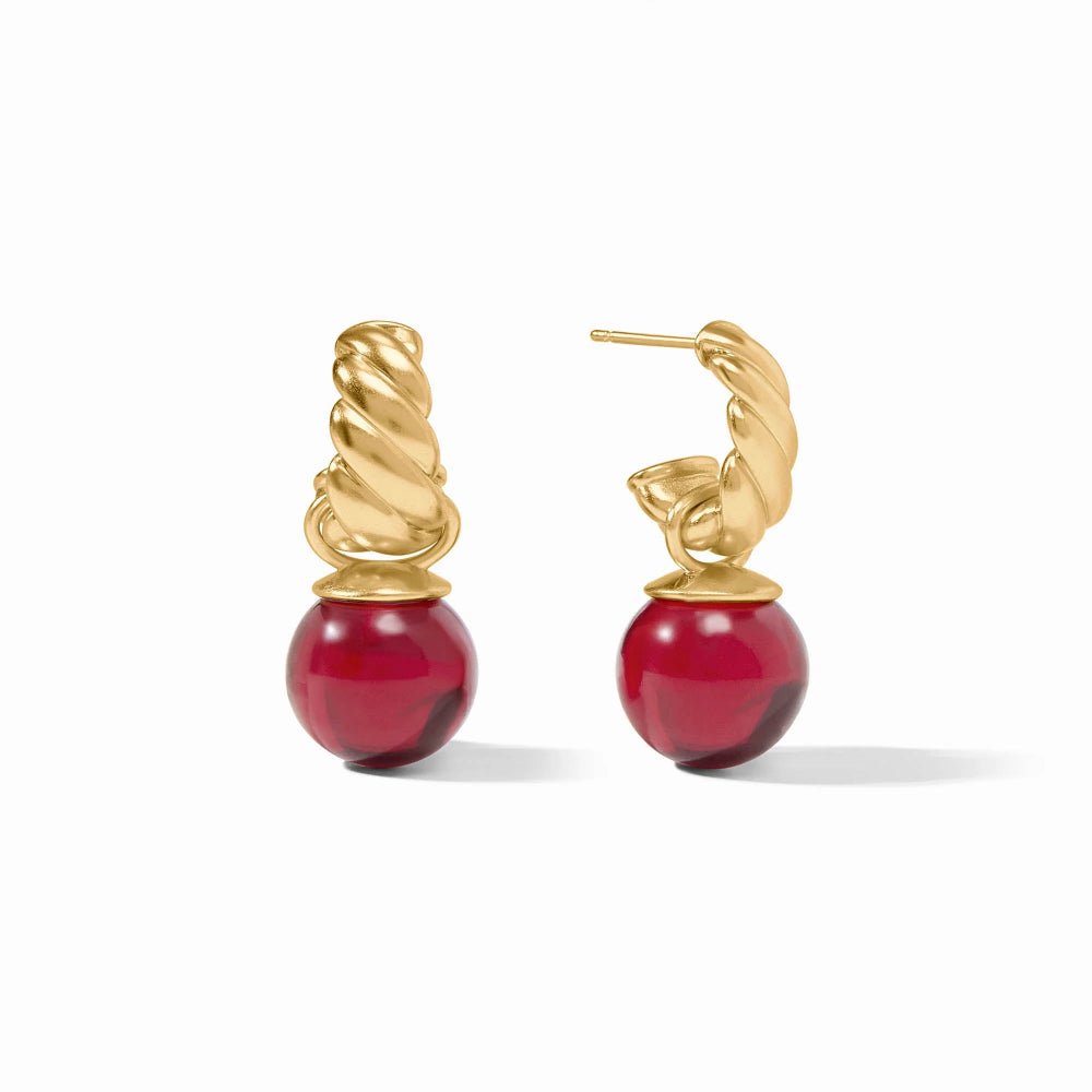 Gold earrings with red beads on a white background