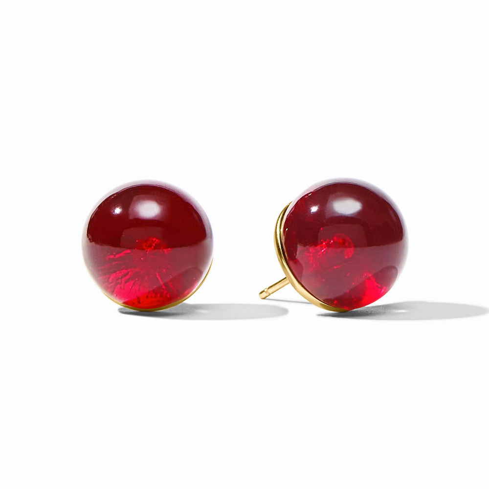 Pair of red round earrings with gold accents on a white background