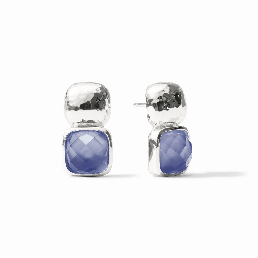Pair of silver earrings with blue gemstones on a white background