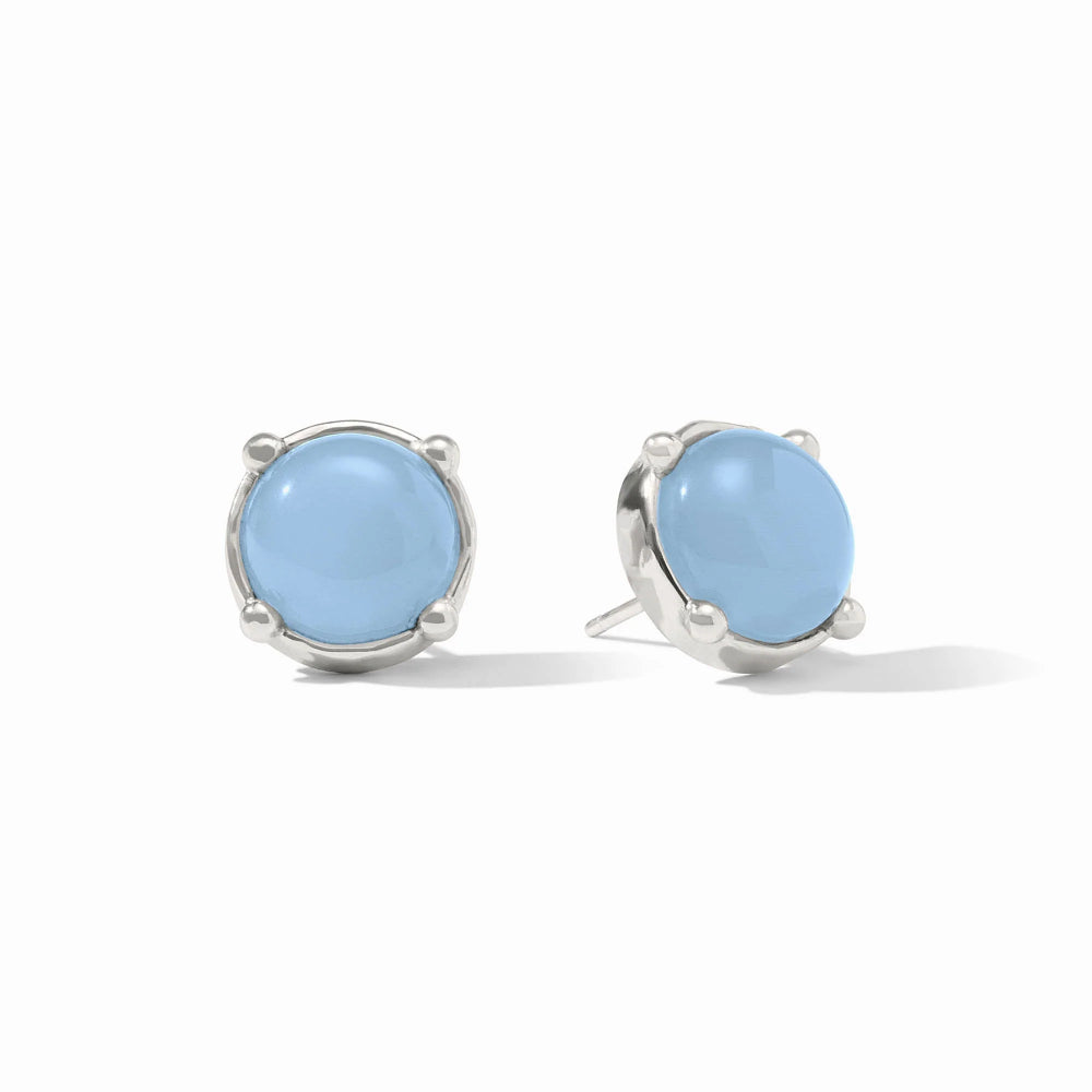 Pair of silver earrings with light blue gemstones on a white background