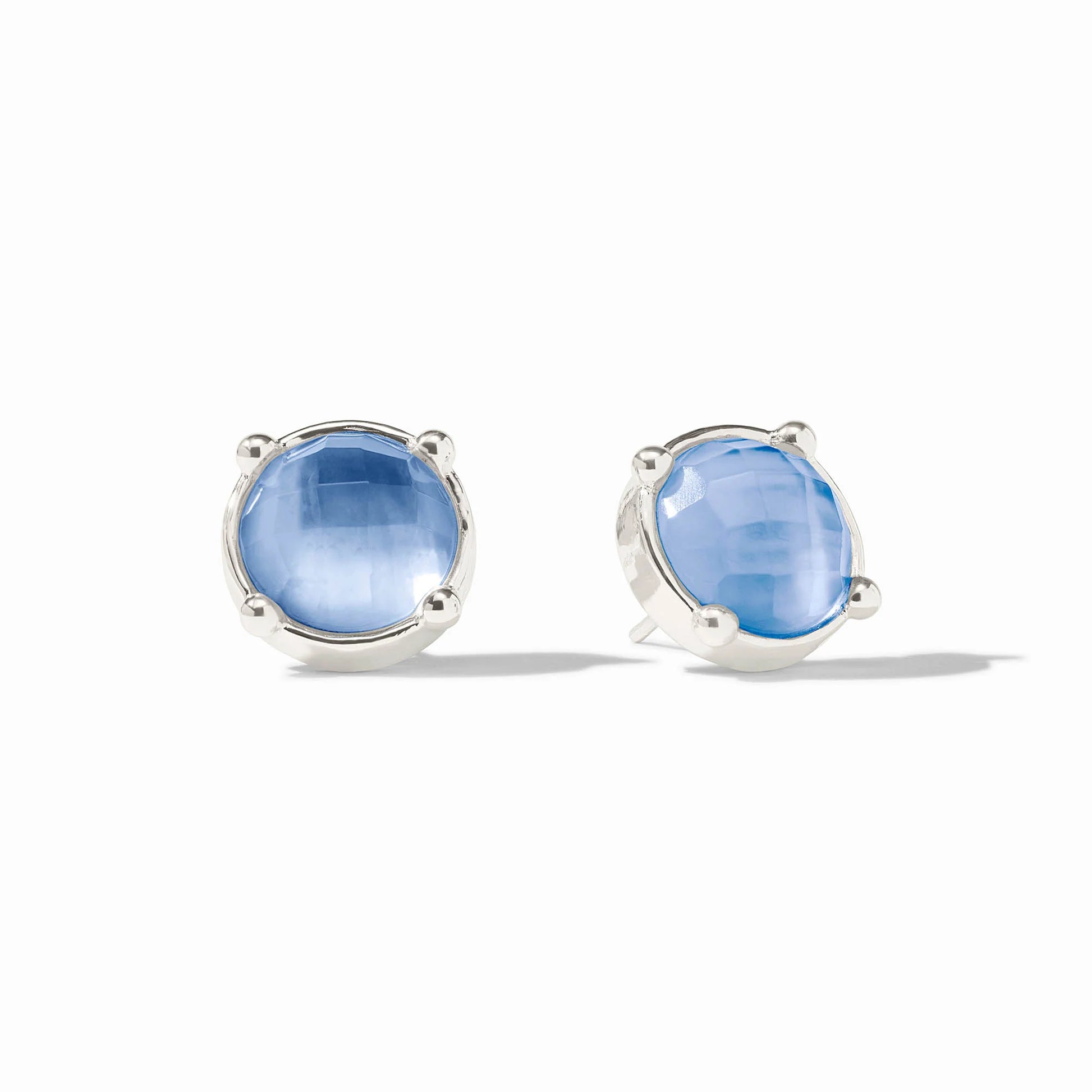 Pair of silver earrings with blue gemstones on a white background