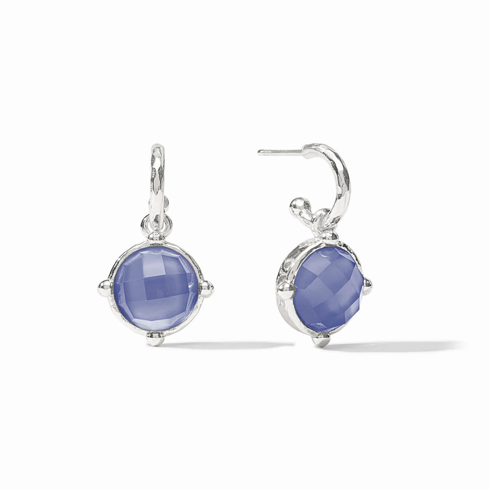 Pair of silver earrings with blue gemstones on a white background