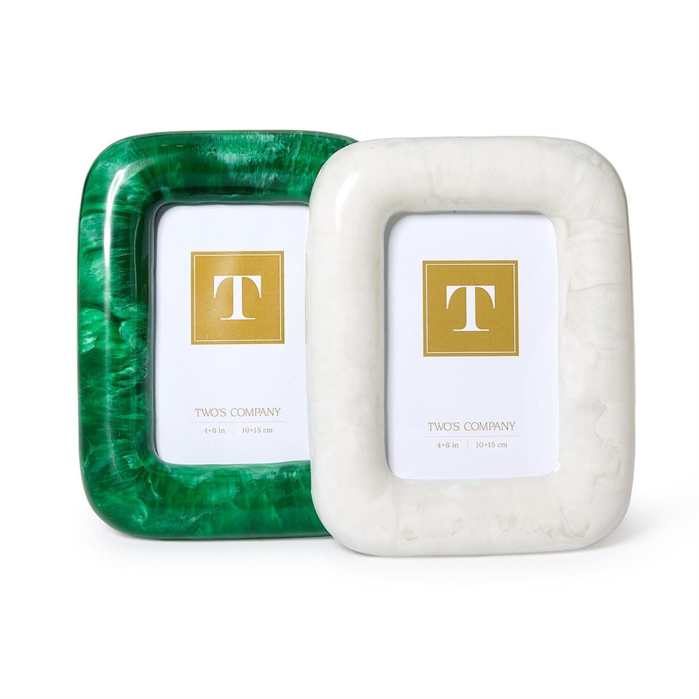Two square picture frames from Twos Company on a white background. One frame is emerald green with a marbled pattern, and the other is white with a subtle marble texture.