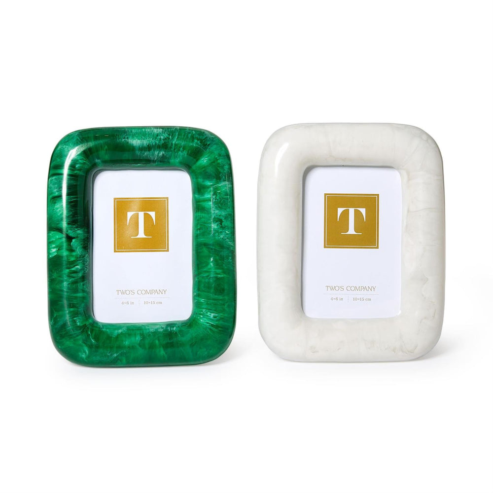 Two square picture frames from Two's Company on a white background. The left frame has a vibrant green marbled pattern, and the right frame has a white marbled pattern.