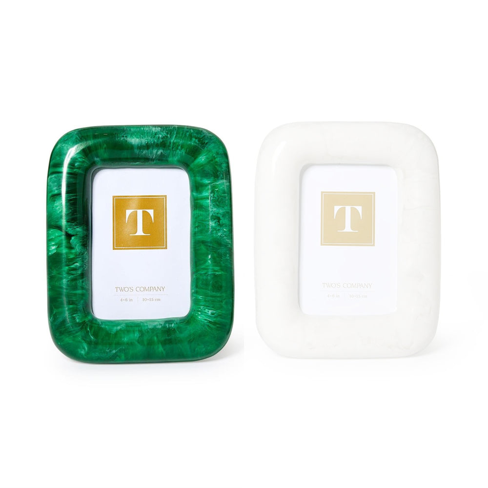 Two square picture frames from Two Company on a white background. The left frame is emerald green with a marbled pattern, and the right frame is white with a subtle marble texture.
