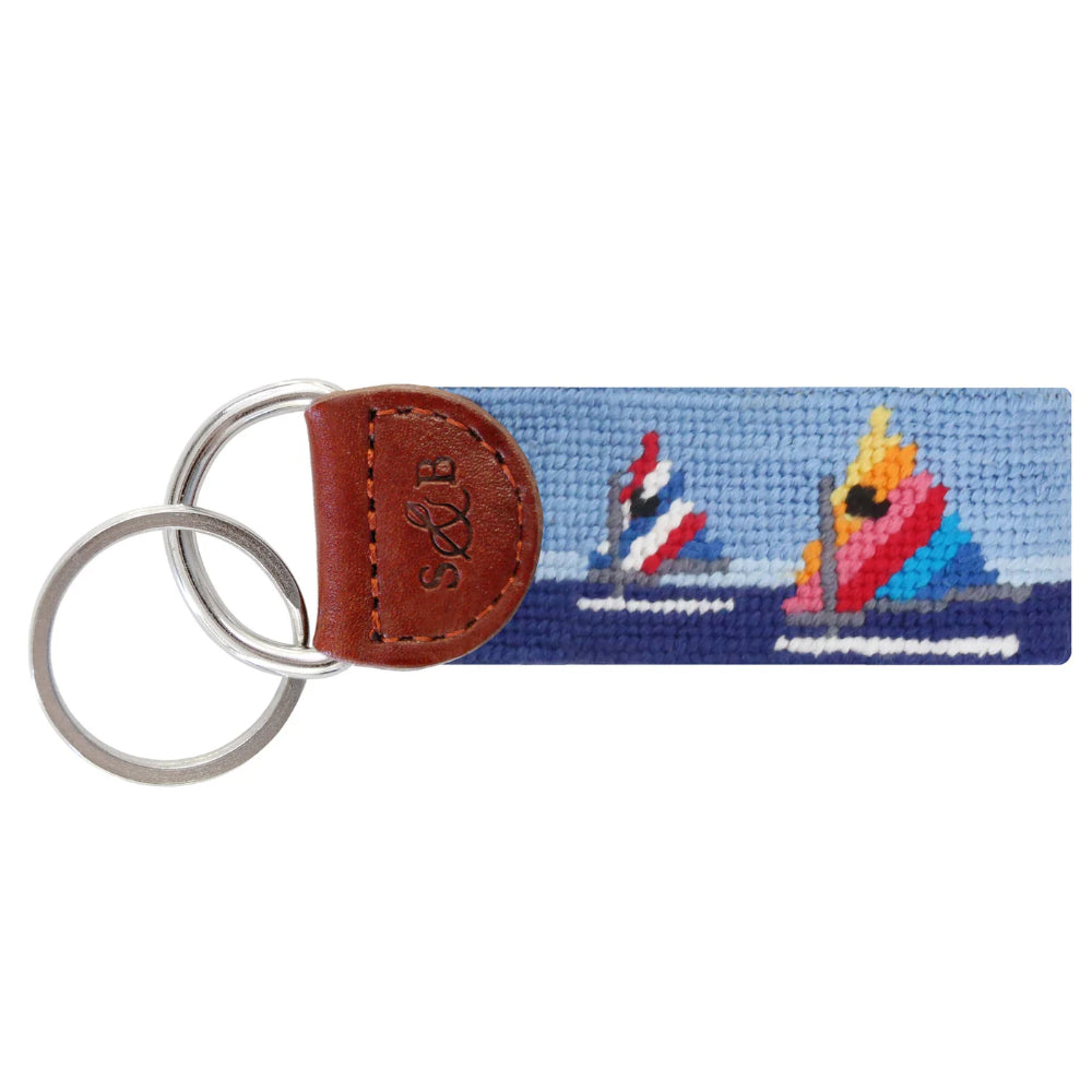 Keychain with sailboat design on a white background