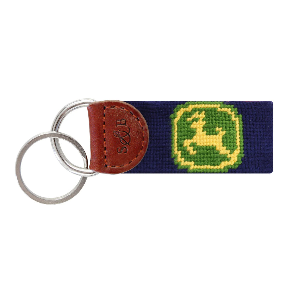 Smathers & Branson keychain with green and yellow John Deere logo on  navy with a brown leather tab on a white backround 