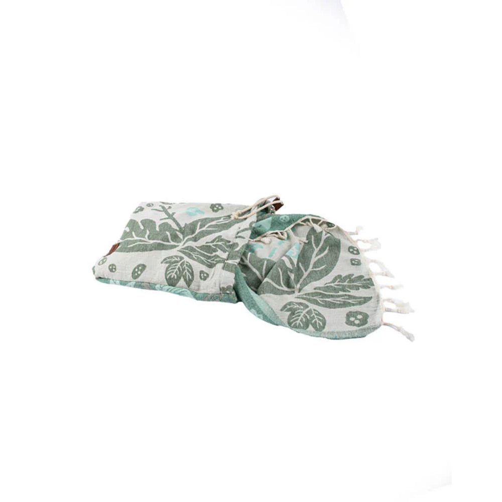 Green beach towel with tassel on a white background
