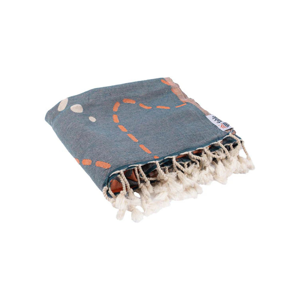 Blue towel with white and orange patterns on a white background.