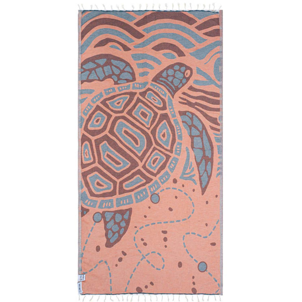 Red stone colored beach towel with turtle design on a white background.