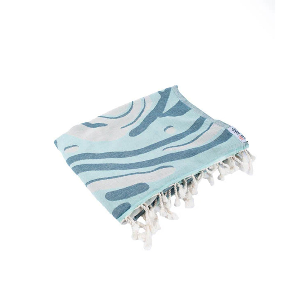 Blue and white shark patterned towel with white tassels on a white background.