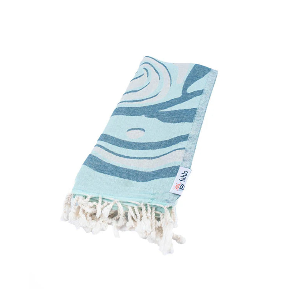 Blue and white shark patterned towel with fringes on a white background.