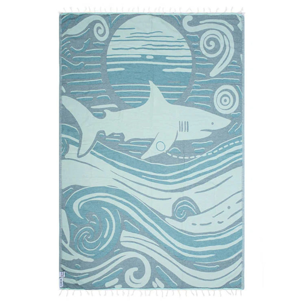 Side two of a blue Shark-themed beach towel with wave design on a white background.