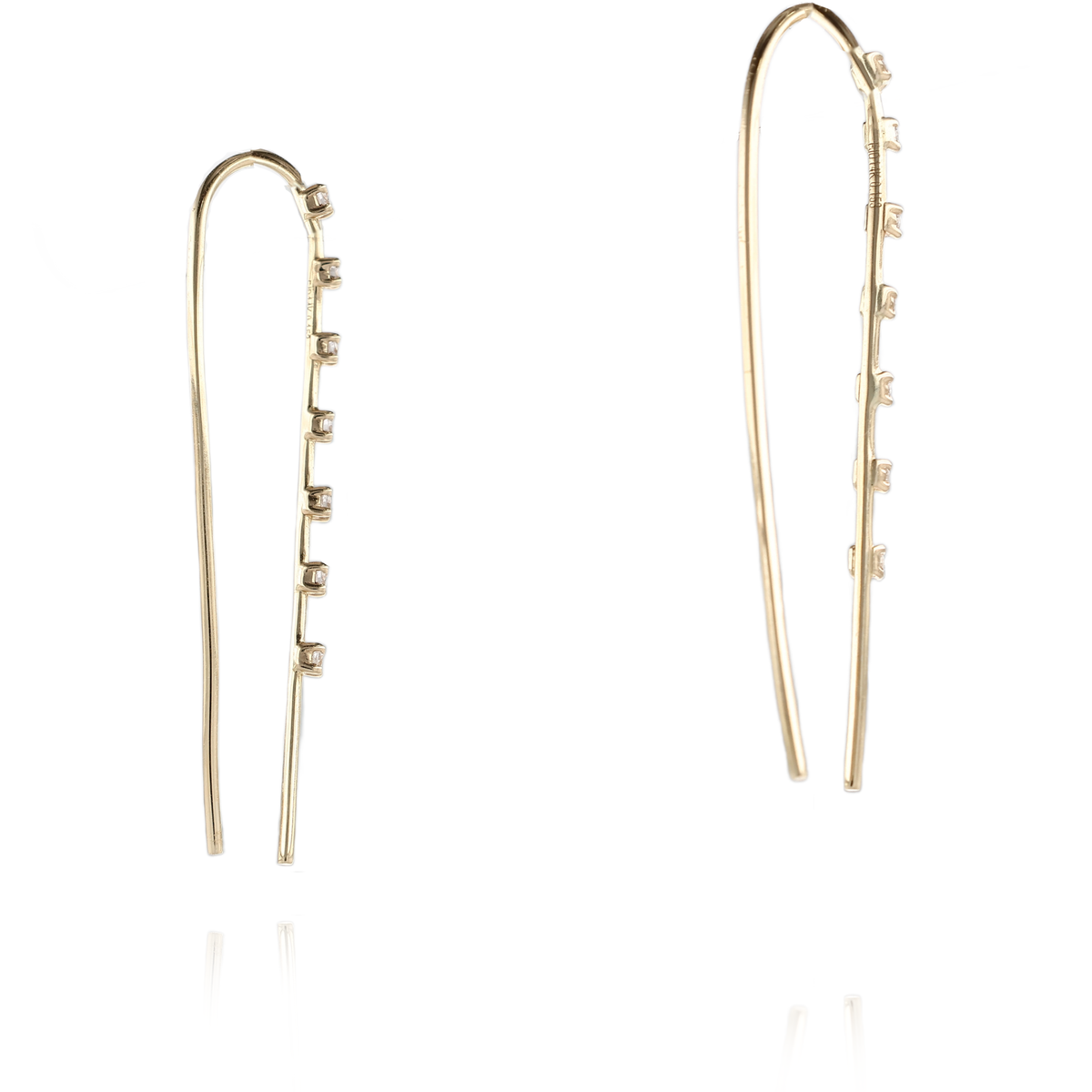 A pair of gold drop earrings with a slim, branching design accented by small clear gemstones, shown against a solid white background.