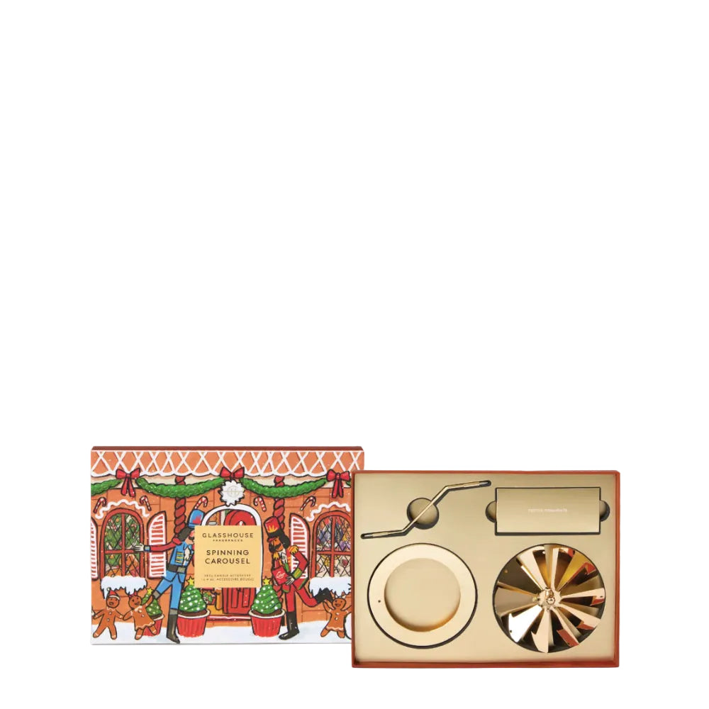 A luxury gift set featuring a Christmas-themed illustrated box on the left and the gold-toned carousel product tray on the right, set against a clean white background.