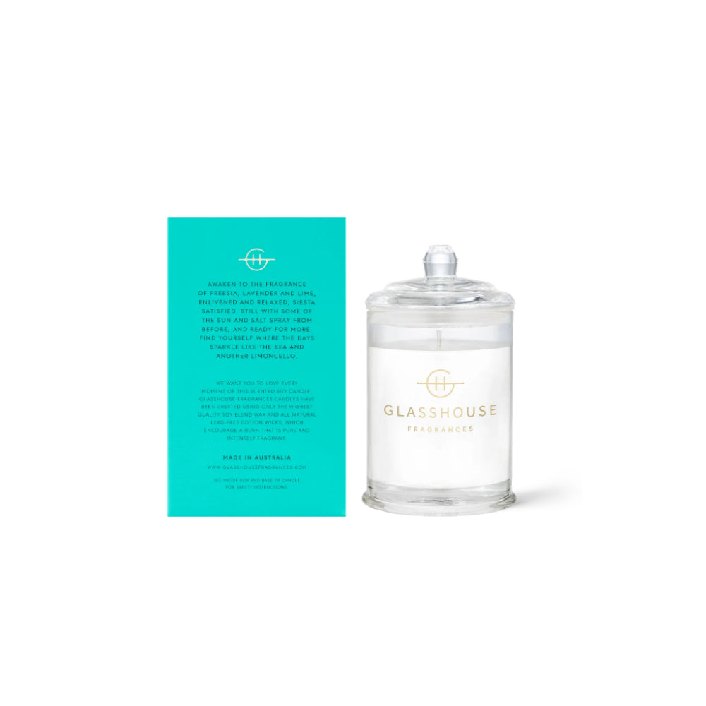 Glasshouse candle with teal packaging on a white background