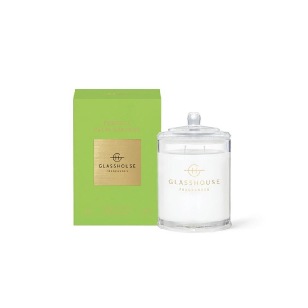Glasshouse candle "Picture Perfect Palm Springs" clrear candle and green packaging on a white background.